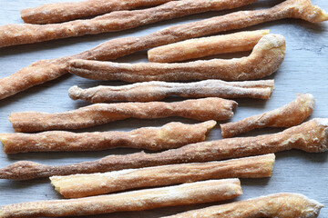 Italian grissini all'acqua or salted bread sticks on wooden background. Close up