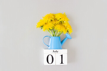 1st July. Summer calendar date and yellow dandelions flowers in blue watering can on gray background. Planner template. Organizer diary. Event schedule date. Planning concept. Event reminder