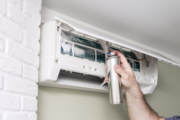 air conditioner cleaning with spray foam cleaner © Елена Гурова