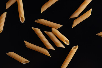Dried pasta isolated on black background.