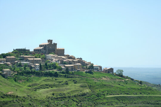 village of Ujué on top of a green hill in the sierra de Ujue, Navarra, Spain