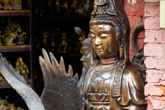 Close-up of metal bodhisattva buddha statues sold in the market