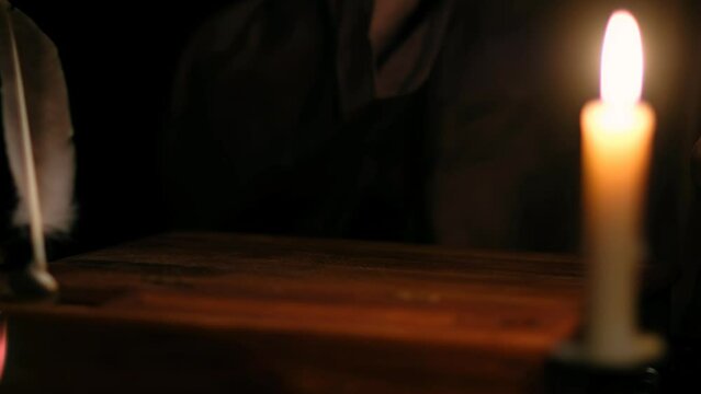 Video of ld monk takes a manuscript out of the document box, signs it, wet paperweight, and puts it back.