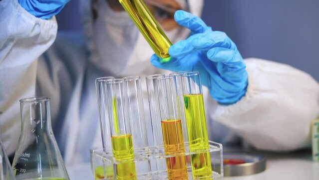 Female scientist experimenting with oil in a science lab.