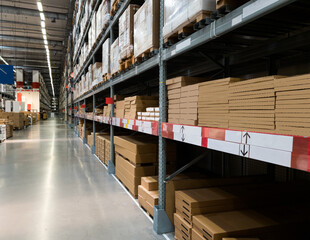 Distribution warehouse interior. Shelve with boxes in modern factory warehouse.