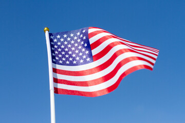 USA flag waving in blue sky