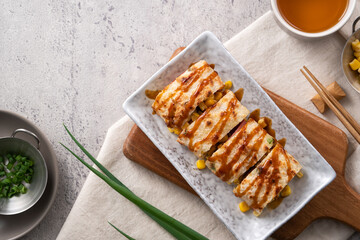 Delicious Taiwanese omelette, egg pancake roll with ham and corn kernels.