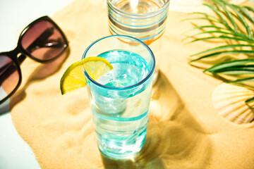 Summer alcoholic cocktails in colorful glasses on beach with white sand. Summer sea ocean vacation and travel concept