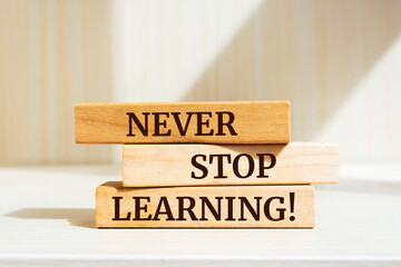 Wooden blocks with words 'NEVER STOP LEARNING!'.