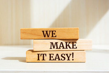 Wooden blocks with words 'We make it easy'. Business concept.
