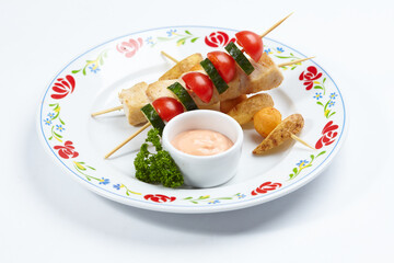 chicken kebab with sauce and herbs