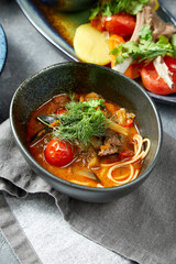 Closeup view of soup with beef, noodle and vegetables