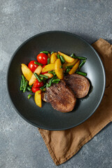 Grilled beef tongue with fried potato and vegetables