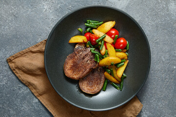 Grilled beef tongue with fried potato and vegetables