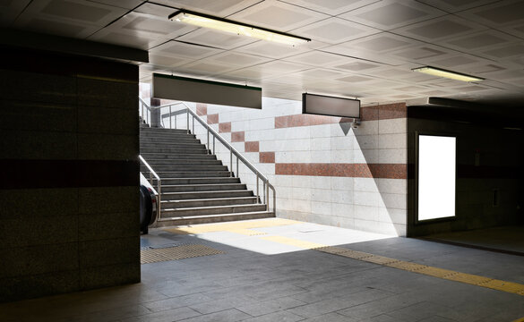 Chairs for waiting in modern metro station with blank poster. front view