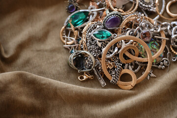 Bunch of stolen jewelry on military uniform cloth fabric. Looting by Russian soldiers in the...