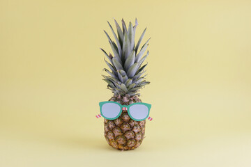 pineapple wearing glasses on yellow background