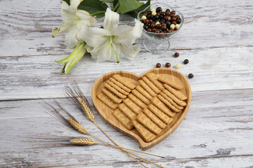 biscuits on wooden floor, next to flowers