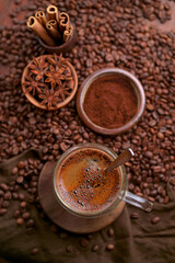 Cup Of Coffee And Coffee Beans On Table.