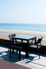 Empty Chair and table with sea on the beach.