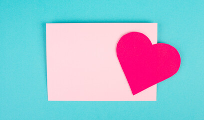 Pink envelope with a heart, empty copy space, blue background, valintines day greeting card, romantic mail, love letter
