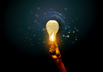 Hands pointing Light bulb on dark background - New icon business - creativity idea and concept -...