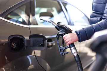 Refueling the car at a gas station fuel pump, car refueling on petrol station, fuel pump at station