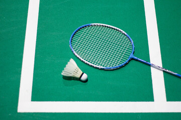 badminton balls and badminton rackets Shuttlecock in green badminton court used in competition