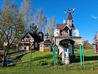 Unusual and beautiful fairy tale houses and carved wooden figures in the Latvian village of...