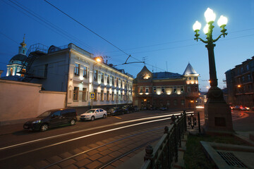 Moscow, Russia - July, 27 2014: Historical buildings in Moscow center at night. Mansion on Yauza boulevard. Tram rails and light traces on foreground.