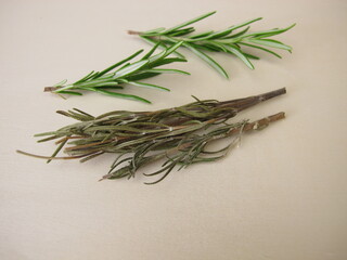 Fresh and dried rosemary on a wooden board