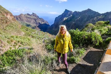 Naklejka premium woman on Mountain village Masca on Tenerife, Spain. Tenerife landmark landscape