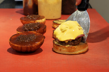 Burgers, hamburgers or cheeseburgers on the restaurant kitchen counter ready to be served.