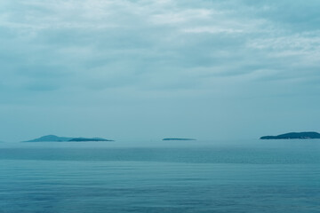 Minimal panoramic view of islands on the sea, sky and clouds on a moody overcast day