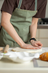 View of the chef's hands in the process of cooking. Copy space, vertical