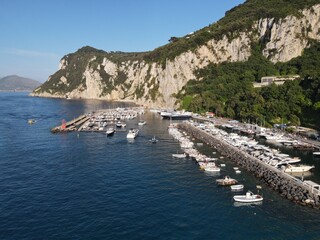 Obraz premium Aerial view of Marina Grande in Capri, an island located in the Tyrrhenian Sea off the Sorrento Peninsula, on the south side of the Gulf of Naples in the Campania region of Italy. Drone view of Capri.