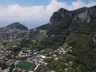 Fototapeta na wymiar Aerial view of Marina Grande in Capri, an island located in the Tyrrhenian Sea off the Sorrento Peninsula, on the south side of the Gulf of Naples in the Campania region of Italy. Drone view of Capri.