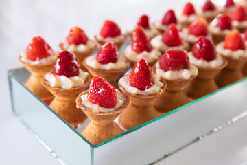 Mini Strawberry Fruit appetizing Tarts. Pastry cupcake dessert with strawberry fruits and cream