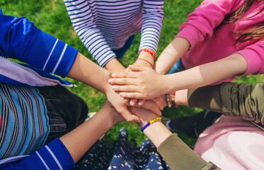 People put their hands together. Selective focus.