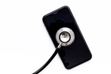 Obraz na płótnie Canvas Mobile phone with stethoscope, electronics repair concept