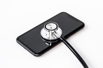 Obraz na płótnie Canvas Mobile phone with stethoscope, electronics repair concept