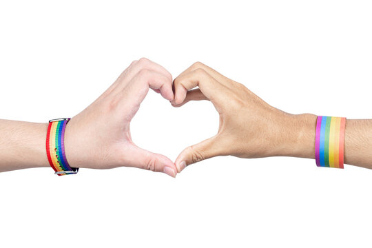 Human hands with LGBT rainbow flag wristband showing heart shape