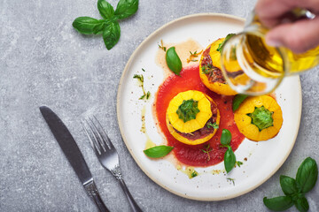 Stuffed zucchini. Round yellow zucchini stuffed with meat and vegetables served on plate.