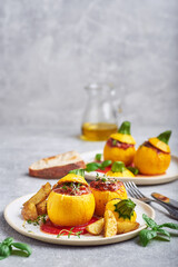 Stuffed zucchini. Round yellow zucchini stuffed with meat and vegetables served on plate.