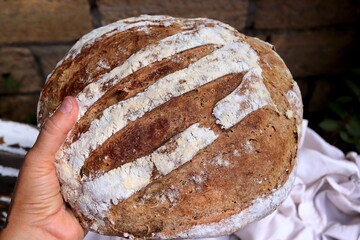 Traditional sourdough bread on a wooden board, close-up view