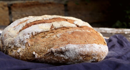 Traditional sourdough bread on a wooden board, close-up view