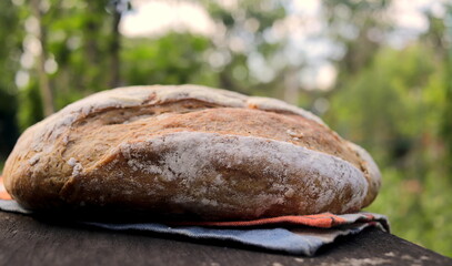 Traditional sourdough bread on a wooden board, close-up view