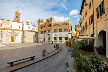 Fototapeta na wymiar Morning view on Piazza Dante, central square in Grosseto town on sunny day. This city is the center of Maremma region at western central Italy