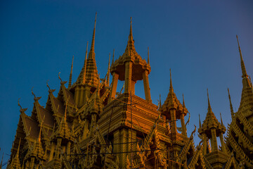 Fototapeta premium The background of religious attractions in Phitsanulok Province (Wat Chan Tawan Tok) has a distinctive golden yellow sculpture, close to the Nan River, tourists always come to make merit in Thailand