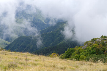 Fog revealing the mountain range in Ligurian Alps, Italy